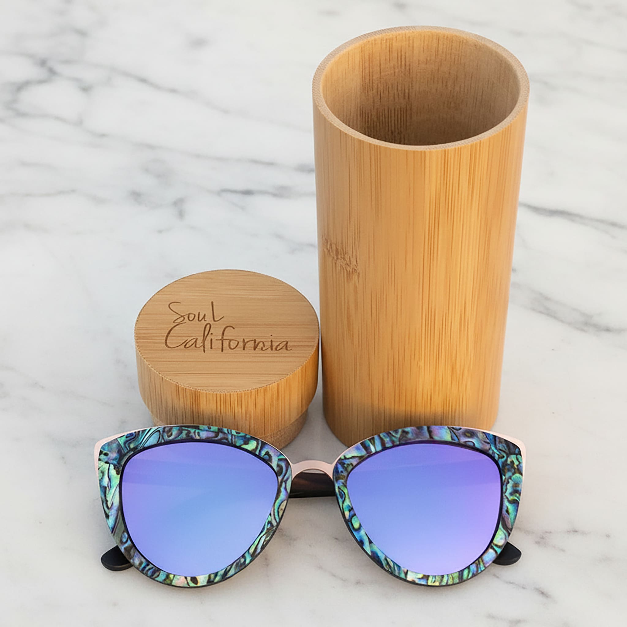 Soul California Eyewear Hermosa Beach Lilac sunglasses front view with case, featuring ebony wood and New Zealand abalone paua shell frame with lilac mirrored polarized UV400 lenses.