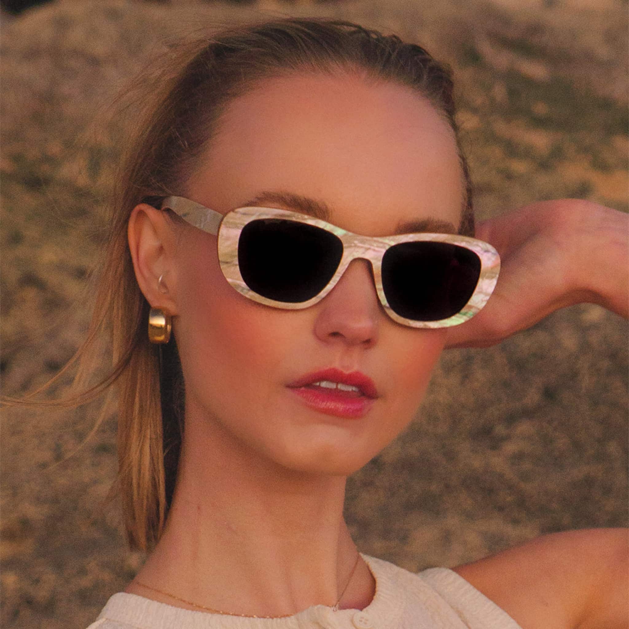Model wearing Soul California Eyewear Moonlight Beach sunglasses featuring handcrafted zebra wood and mother of pearl frame with coastal-inspired design.