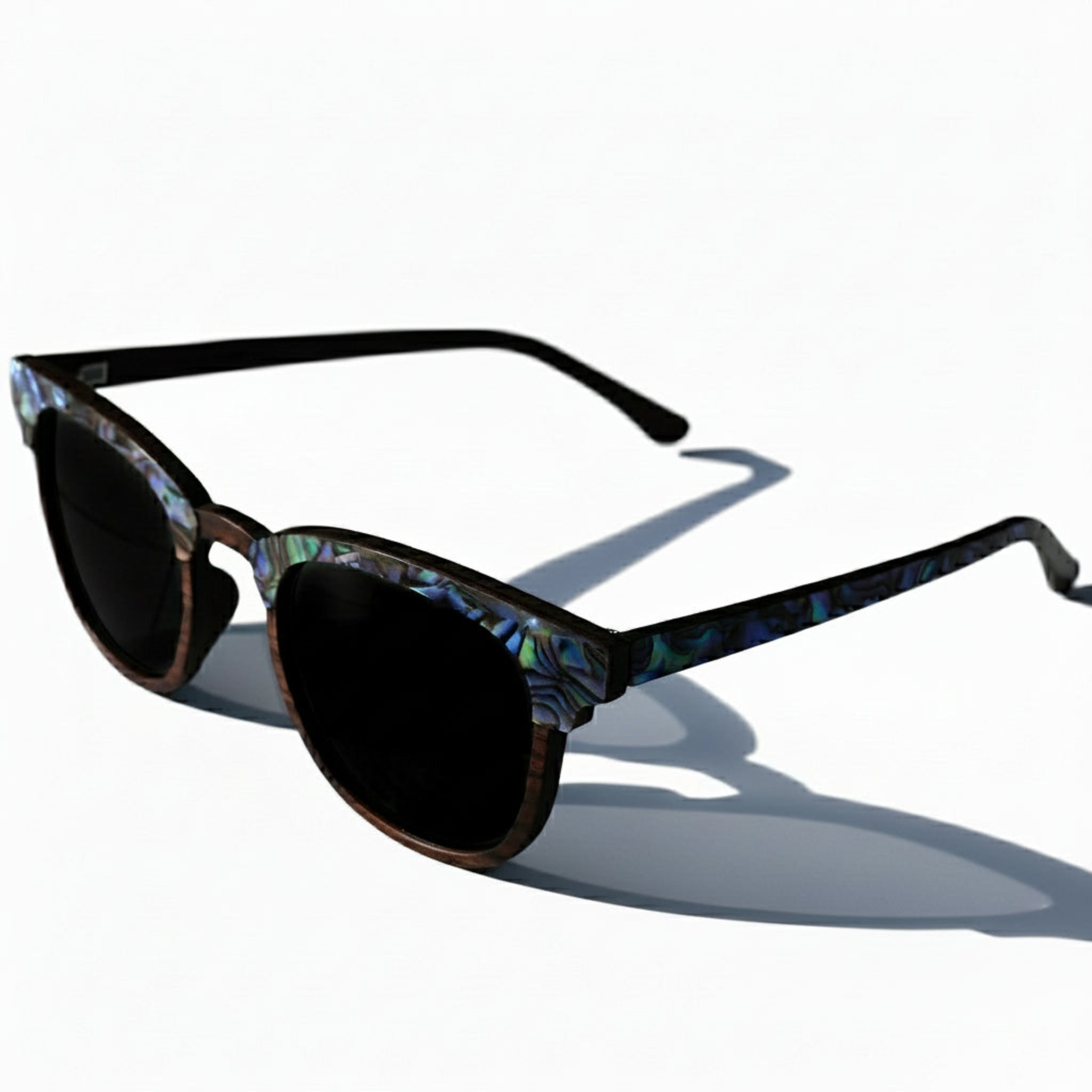 Angled top view of Soul California Eyewear Pebble Beach Dusk 2 sunglasses highlighting abalone shell detail and smooth handcrafted ebony wood frame.