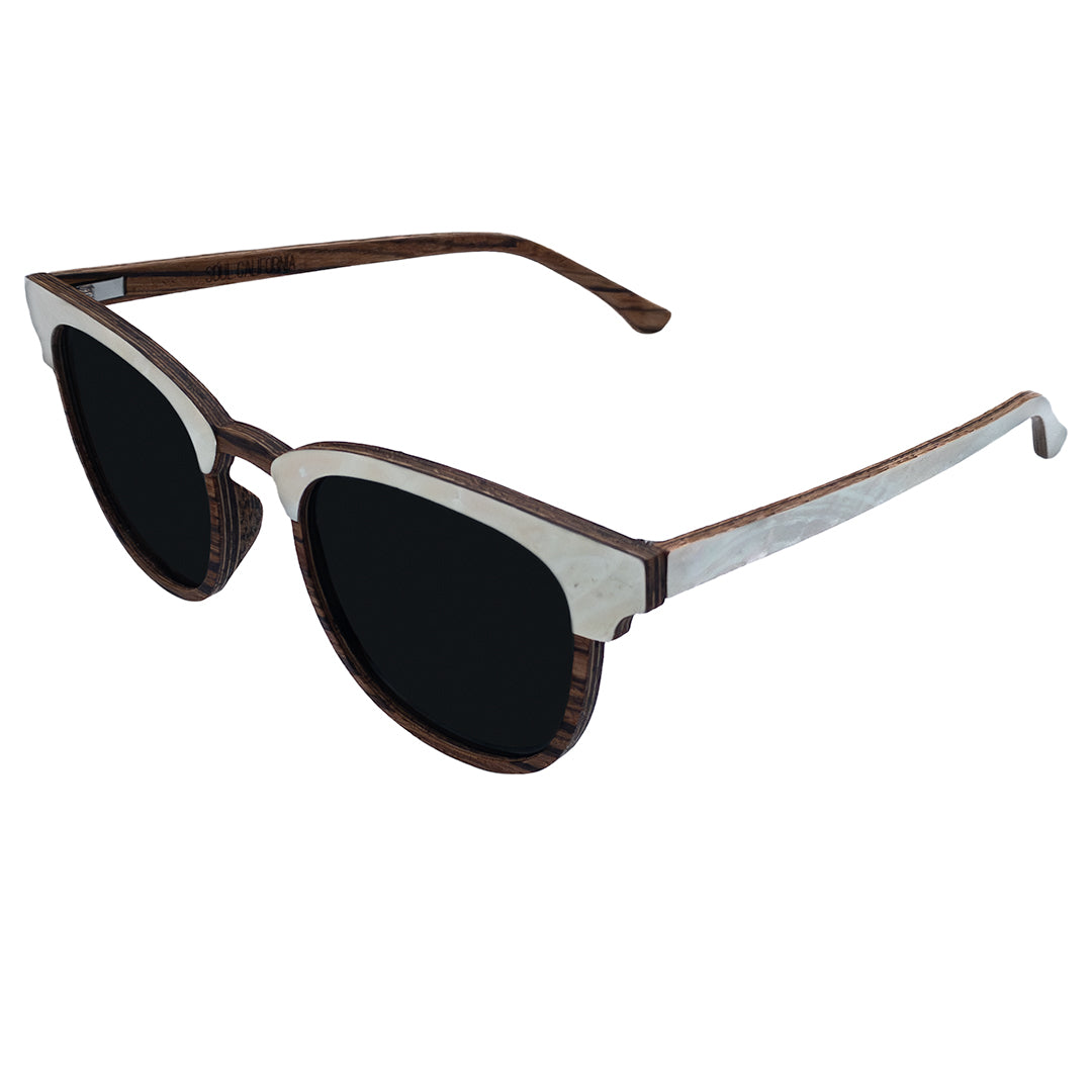 Angled top view of Soul California Eyewear Pebble Beach Pearl sunglasses highlighting mother of pearl detail and handcrafted zebra wood frame.
