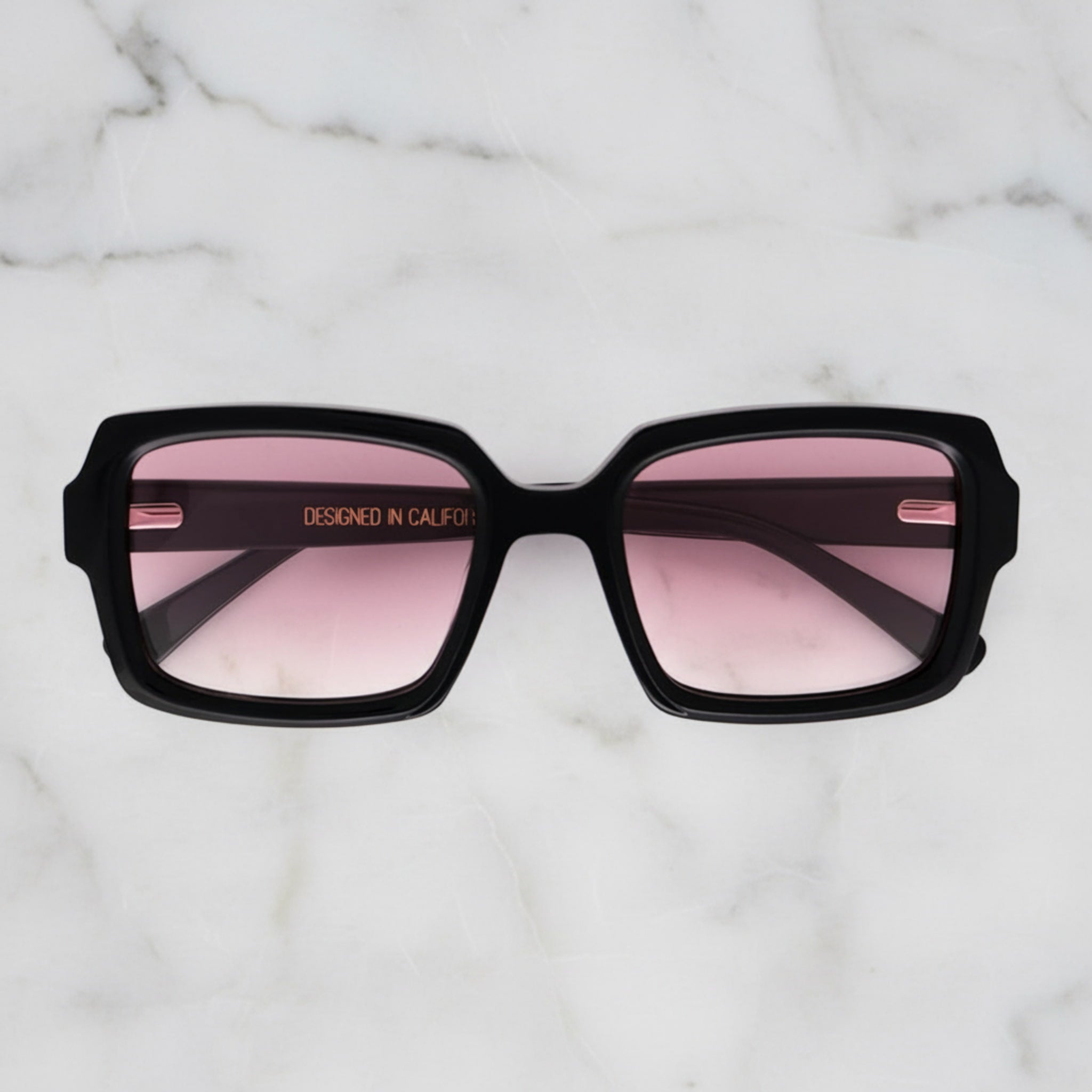 Soul California Eyewear Rosara sunglasses front view with black acetate frame and pink gradient lenses.
